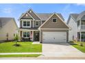 Beautiful two-story home with well-kept lawn, attached garage, and appealing curb appeal at 476 Foxbank Plantation Blvd, Moncks Corner, SC 29461