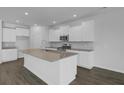 Spacious kitchen with granite countertops, white cabinetry, and stainless steel appliances at 553 Richfield Way, Summerville, SC 29486