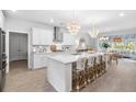 Bright, modern kitchen with white cabinets, quartz countertops, and a large island with seating at 606 Dunswell Dr, Summerville, SC 29486