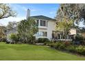 Back exterior of home surrounded by lush landscaping, large windows, and a deck at 739 Stiles Dr, Charleston, SC 29412