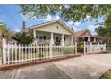 Charming home with a picket fence, lush landscaping, and a welcoming front porch at 798 Rutledge Ave, Charleston, SC 29403