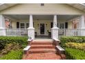 Inviting front porch with classic columns and brick steps at 798 Rutledge Ave, Charleston, SC 29403