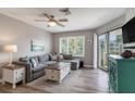 Cozy living room with a sectional sofa, stylish coffee table, and access to a private balcony at 9000 Palmetto Dr # 202-C, Isle of Palms, SC 29451
