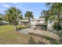 Expansive backyard featuring palm trees, a hot tub, and a wooden deck at 939 Mikell Dr, Charleston, SC 29412