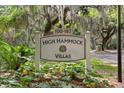 High Hammock Villas community sign featuring lush greenery and mature trees at 113 High Hammock Villas, Seabrook Island, SC 29455