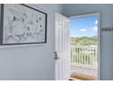 View of the entryway with a beautiful view to the outdoor balcony, artwork and a light blue wall at 114 W Arctic Ave # B302, Folly Beach, SC 29439