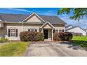 Cozy single-story home featuring a well-kept lawn and neat landscaping at 1209 River Rock Rd, Hanahan, SC 29410