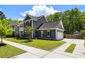 Well-maintained home featuring an attached garage and a neatly manicured lawn with sidewalk at 1233 Updyke Dr, Johns Island, SC 29455