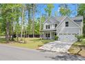 Beautiful two-story home with a well-manicured lawn and a mix of mature trees and new plantings at 1325 Wannamaker Ave, Summerville, SC 29485