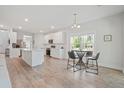 Bright, open-concept kitchen and dining area with wood floors and plenty of natural light at 1325 Wannamaker Ave, Summerville, SC 29485