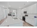 Modern kitchen with white cabinetry, quartz countertops, stainless steel appliances and large island at 1325 Wannamaker Ave, Summerville, SC 29485