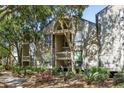 Exterior view of a condo complex with stairs to units, surrounded by trees, shrubs and mulch beds at 1342 Pelican Watch Villas, Seabrook Island, SC 29455