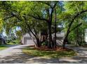 Lovely home featuring a long driveway and a two-car garage surrounded by mature trees at 1392 Eden Rd, Awendaw, SC 29429