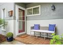 Inviting front porch featuring a cozy bench with decorative pillows and a welcoming welcome mat at 1603 Ventura Pl, Mount Pleasant, SC 29464