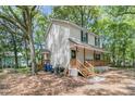 A charming home is nestled among mature trees, with an inviting porch and exterior that exudes classic appeal at 1628 Point Park Dr, Johns Island, SC 29455
