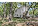 Home exterior with traditional siding, set in a serene wooded environment with mature trees, offering a private retreat at 1628 Point Park Dr, Johns Island, SC 29455