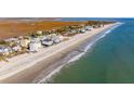 Coastal homes line the beach offering beautiful ocean views and access to the shoreline at 1681 E Ashley Ave # B, Folly Beach, SC 29439
