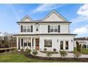 Beautiful two-story home featuring a classic design, black shutters, a welcoming porch, and landscaping at 177 Cantona Dr, Summerville, SC 29483