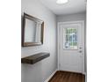 Bright entryway showcasing a floating shelf, decorative mirror, and a clear view of the front door at 1812 Overrun St, Charleston, SC 29414