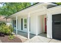 Inviting front porch with white columns and black shutters, leading to the front door at 1812 Overrun St, Charleston, SC 29414