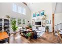 Bright living room featuring hardwood floors, vaulted ceilings, and a large window for natural light at 2 Live Oak Ave, Charleston, SC 29407
