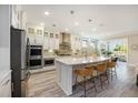 Spacious kitchen with white cabinets, stainless steel appliances, a large island, and modern pendant lights at 200 Clearblue Loop, Summerville, SC 29486