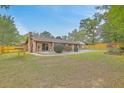 Large backyard featuring a pool, patio, and wooded privacy fence at 201 Hunt Club Dr, Summerville, SC 29485