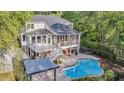 Inviting backyard oasis featuring a pool, covered patio, screened porch, and a relaxing hot tub at 2037 Shell Ring Cir, Mount Pleasant, SC 29466