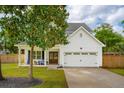 Attractive two-story house with white siding, a lush green lawn, and a convenient two-car garage at 217 7Th Ave, Mount Pleasant, SC 29464