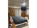Cozy bedroom featuring wood paneling, modern curtains, and a mounted TV at 240 Kerrison St, Varnville, SC 29944