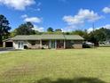 Charming single story brick home with a large front yard and boat parked on the side at 240 Kerrison St, Varnville, SC 29944