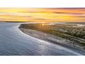 Stunning aerial view of the coastline with beach and beautiful water at sunset at 2530 Jasper Blvd, Sullivans Island, SC 29482