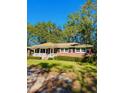 Inviting single-story brick home with a cozy front porch and well-manicured lawn at 26 Elmora Ave, Goose Creek, SC 29445