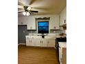 Bright kitchen features classic white cabinets, laminate wood flooring, and modern appliances at 26 Elmora Ave, Goose Creek, SC 29445