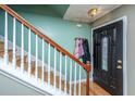 Entryway with hardwood floors, wood staircase, and inviting front door at 3033 Kinswood Ln, Ladson, SC 29456