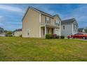 Lawn view of a charming home with vinyl siding, landscaped yard and blue sky at 3033 Kinswood Ln, Ladson, SC 29456