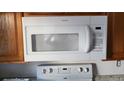 Hotpoint microwave above range in kitchen with wooden cabinets at 315 Indigo Rd, Goose Creek, SC 29445