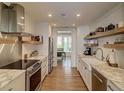 Modern kitchen boasts stone counters, stainless appliances, and open shelving at 330 Concord St # Th 21, Charleston, SC 29401