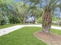 Quaint home nestled among mature trees, showcasing a spacious yard and a welcoming ambiance at 330 Crestwood Dr, Moncks Corner, SC 29461