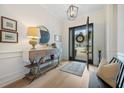 Inviting foyer with light wood floors, stylish console table, rug, and decorative light fixture at 332 Fish Creek Ct, Summerville, SC 29486