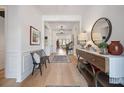 Spacious foyer featuring light wood floors, bench seating, wainscoting, and stylish decor at 332 Fish Creek Ct, Summerville, SC 29486