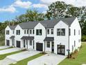 Modern white townhomes with black trim, garages, well-manicured lawns and landscaping at 333 Bremerton Dr, Goose Creek, SC 29445