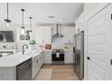 Well-equipped kitchen with stainless steel appliances, a large island, and sleek white cabinets at 333 Bremerton Dr, Goose Creek, SC 29445