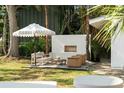 Inviting backyard patio with outdoor fireplace, comfortable seating, and lush landscaping at 40 Dunnemann Ave, Charleston, SC 29403