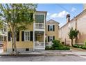Charming two-story home with a welcoming porch and manicured landscaping at 44 Savage St, Charleston, SC 29401