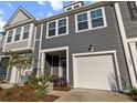 Charming townhome exterior with gray siding, white trim, and well-maintained landscaping at 484 Trotters Ln, Moncks Corner, SC 29461