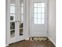 Hallway with white doors and accent rug on hardwood flooring at 505 Eastern Isle Ave, Summerville, SC 29486