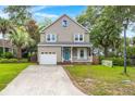 Charming two-story home with a well-manicured lawn and attached garage at 5703 St Angela Dr, North Charleston, SC 29418