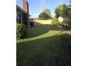 Large, shady backyard featuring a freshly installed wood fence and lush green grass at 5937 Willard Dr, Hanahan, SC 29410