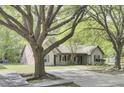 Traditional-style home with mature trees, a brick accent wall, and a paved driveway for convenient parking at 621 Temple Rd # A, Ladson, SC 29456